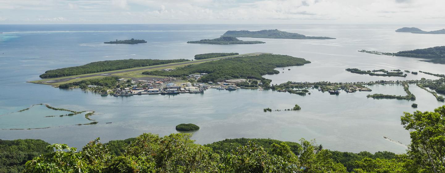 An aerial shot of a group of islands, depicted by green masses of land in a vast body of water