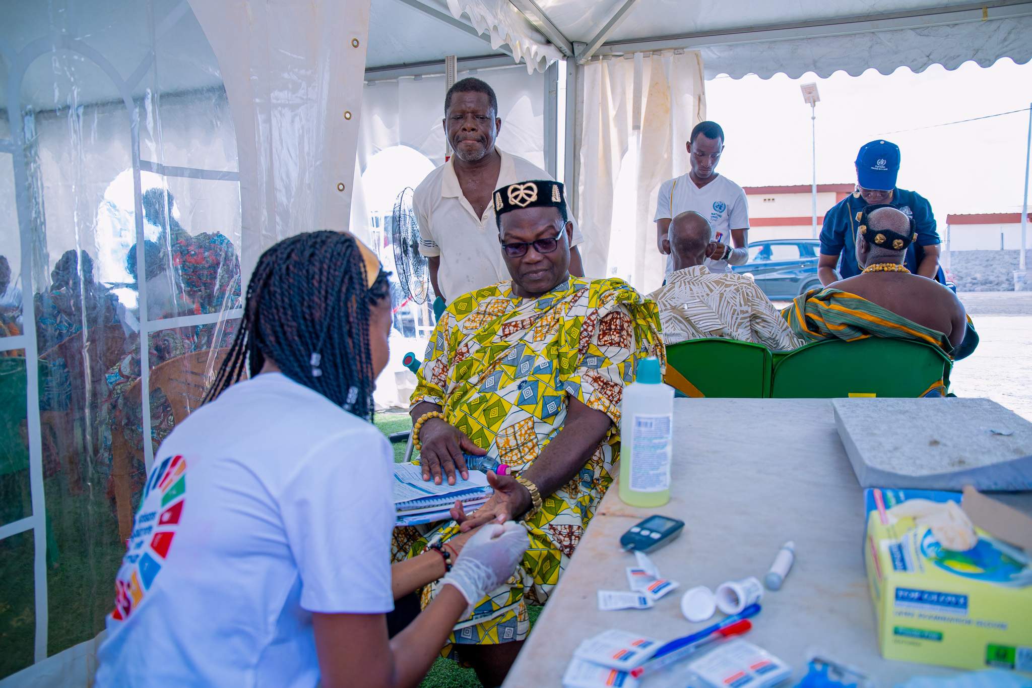 Togolese healthcare workers interact with patients.