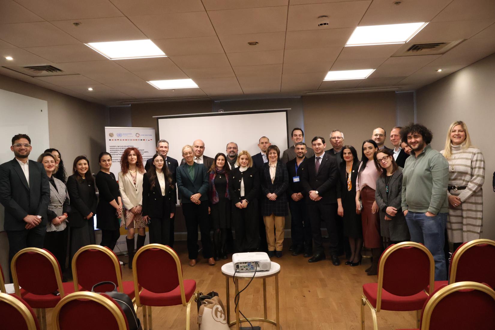 Several UN and national officials take a group photo in Armenia during the official launch of a new programme.