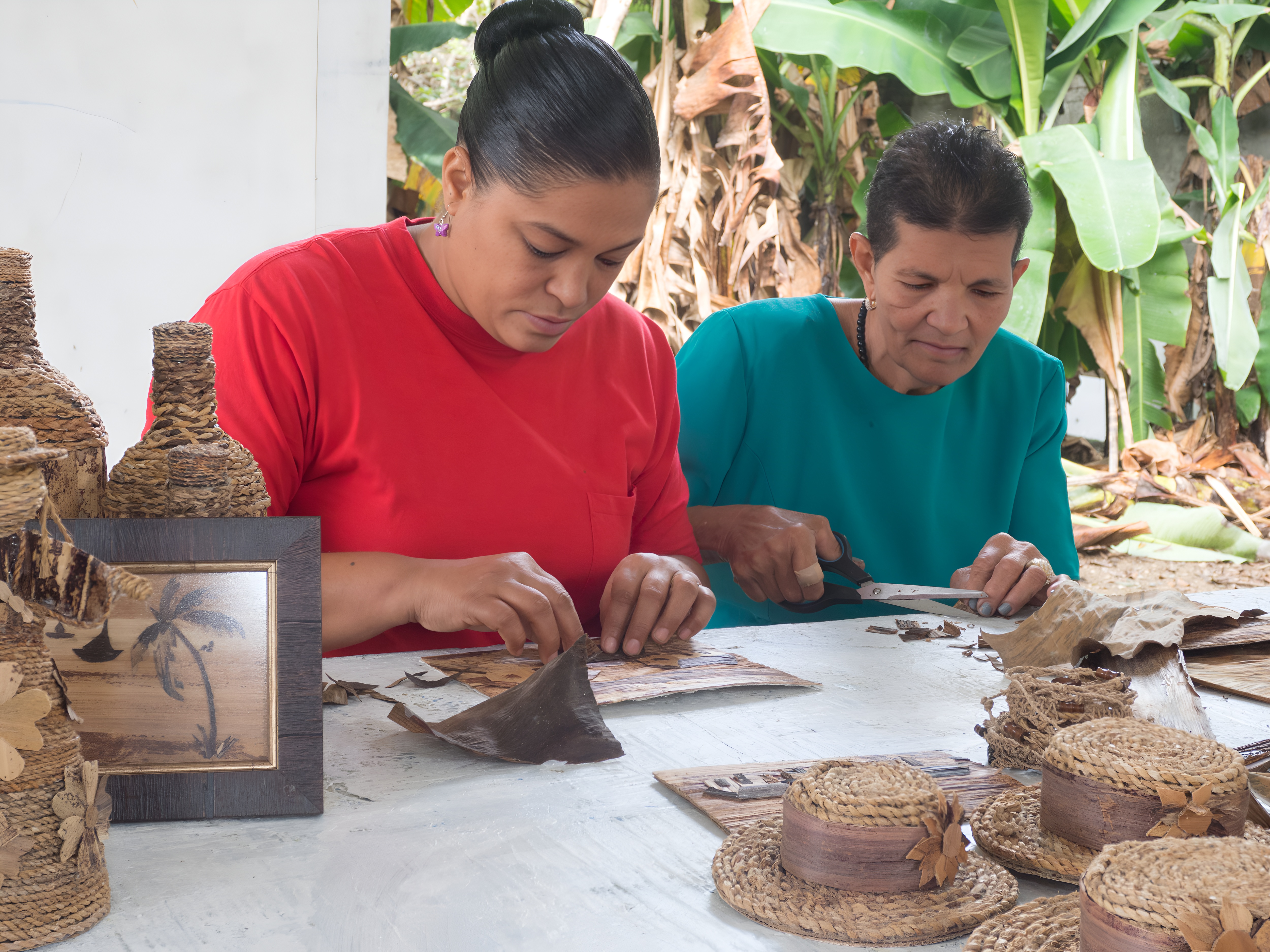 Two women in the Dominican Republic make hats.