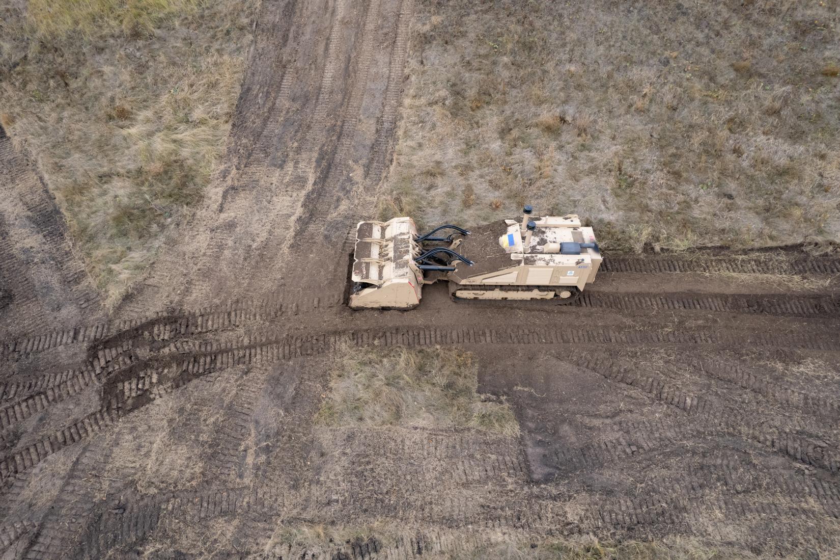 A demining truck in Ukraine sweeps a contaminated field.