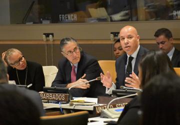 two men and a women sit at a panel discussion 