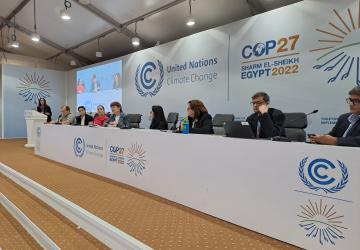 people sit at a panel discussion 