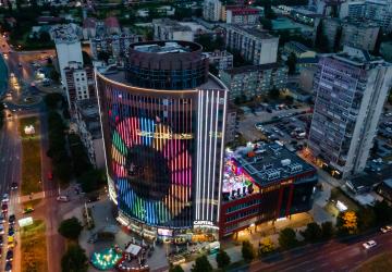 Birdseye view of buildings light up in the dark with SDG symbol 