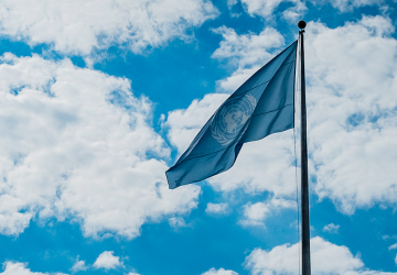 UN flag against cloudy sky 