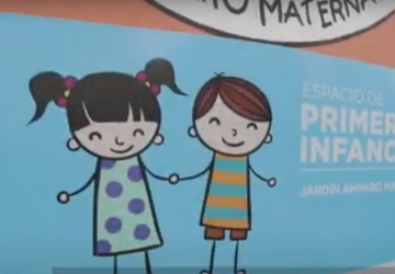 A cartoon depicted on a brick-reddish wall, showing two stick figures clasping hands