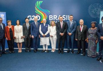 Secretary-General António Guterres with a group of G20 heads of sttae in front of a blue banner that says Brazil G20