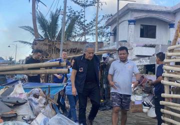 The RC walks in an area with construction being led by a community leader 