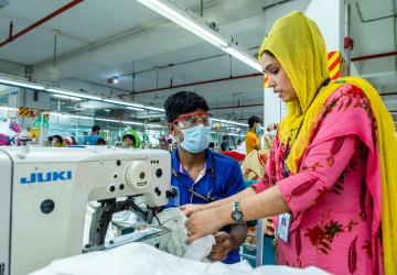 A woman and a man with a sewing machine 