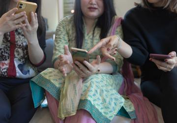 Three women using smartphones.
