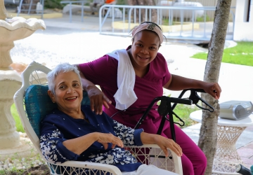 An elderly woman in the Dominican Republic with her caretaker.