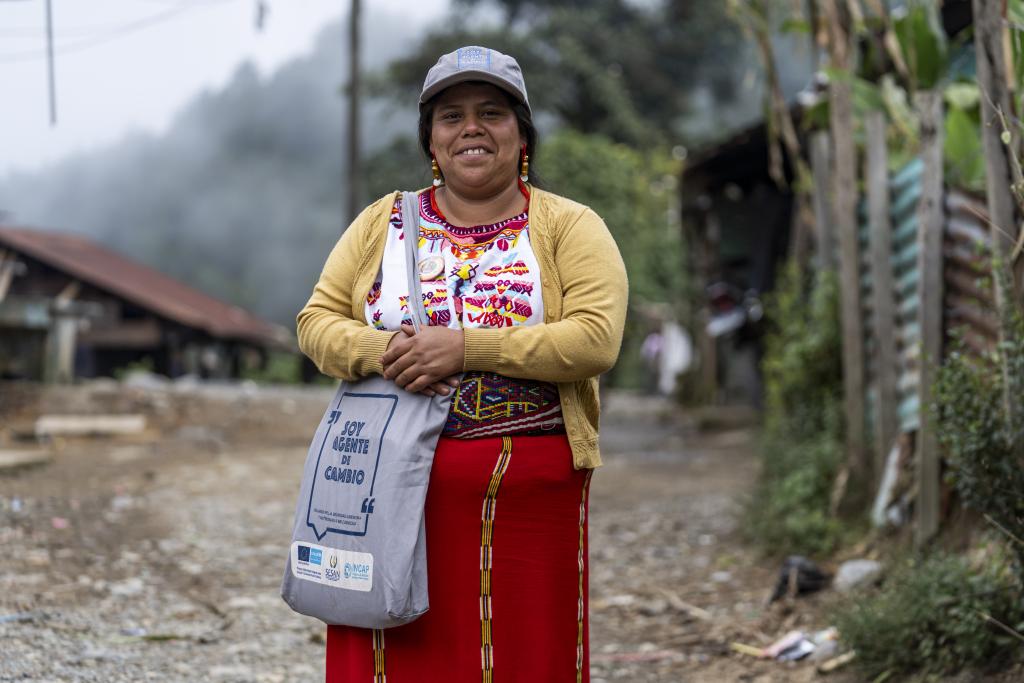 A woman looks at the camera and smiles