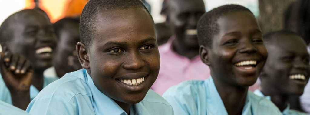 A group of young people looking at the camera and smiling 