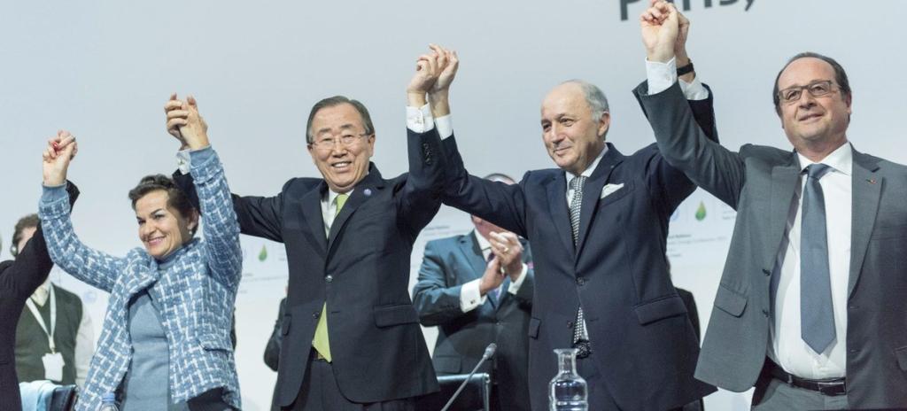 World leaders celebrating the adoption of a historic agreement.