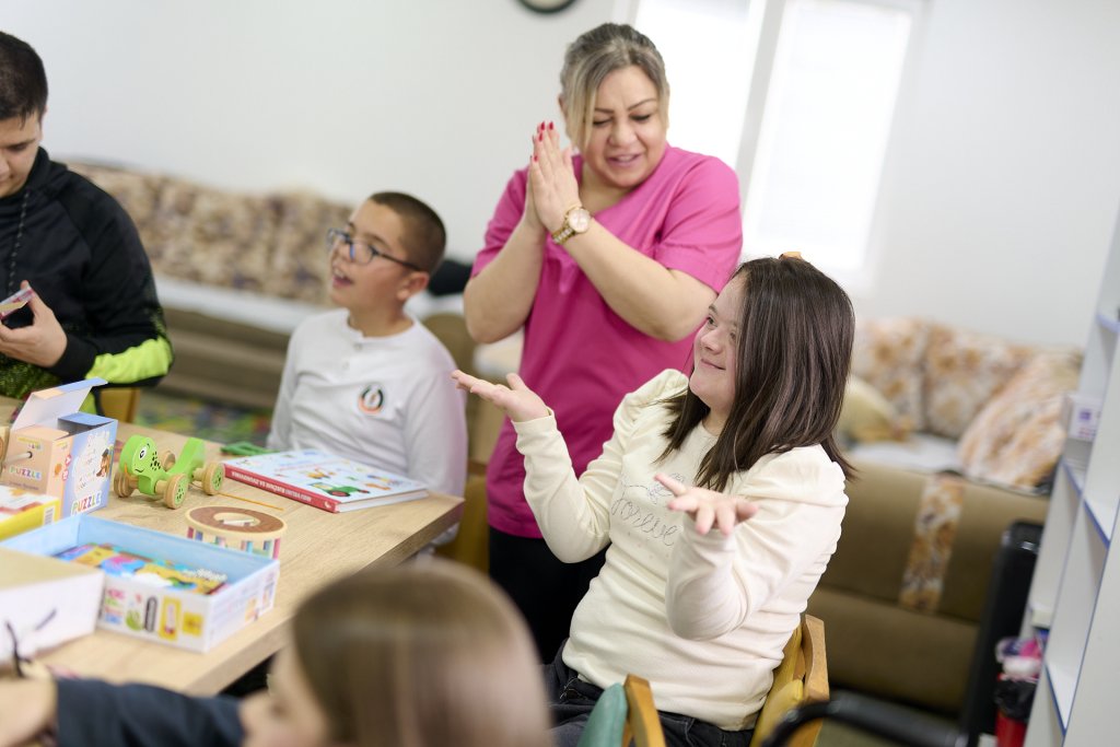 Adult playing with two children.