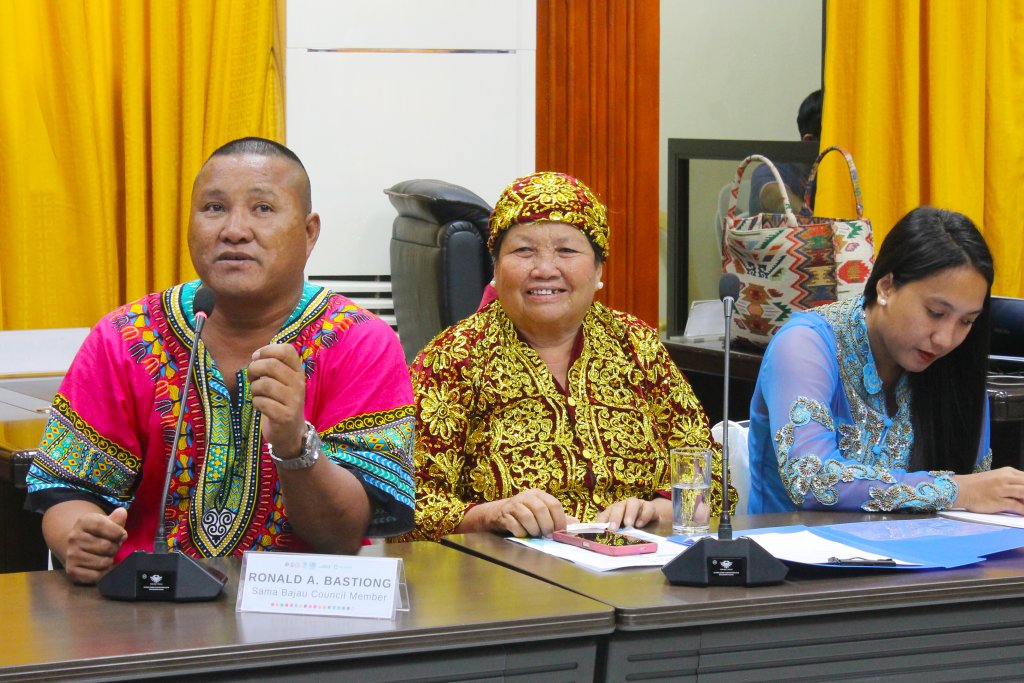Three Indigenous community members participate in a local council in the Philippines.