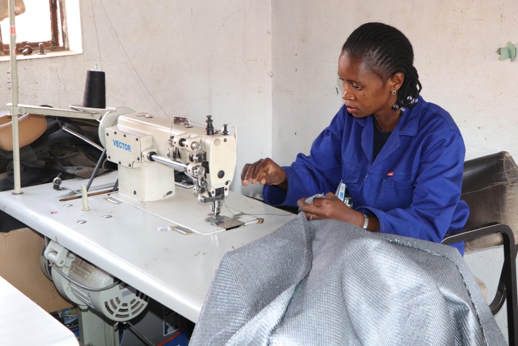 A woman uses a sewing machine in Eswatini.