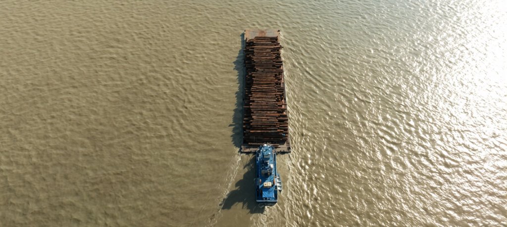 A logging ship navigates along the Amazon River.