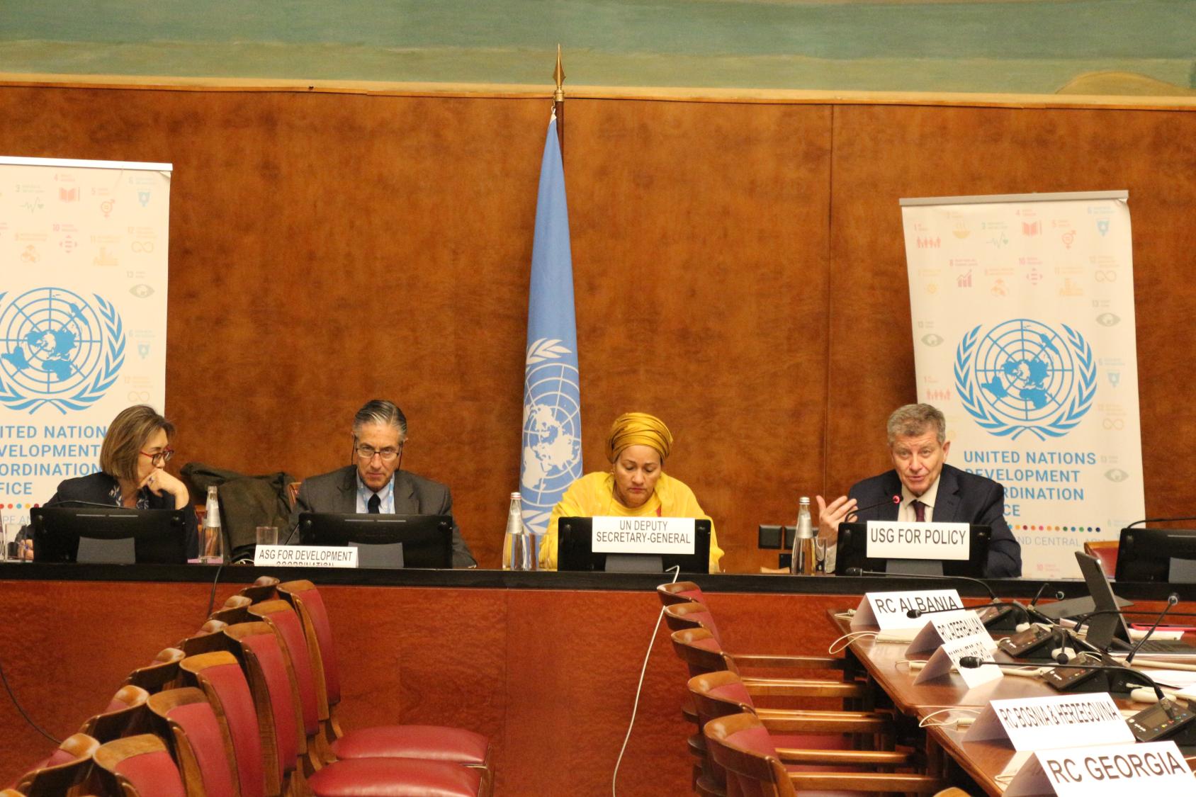 Four speakers at the podium 