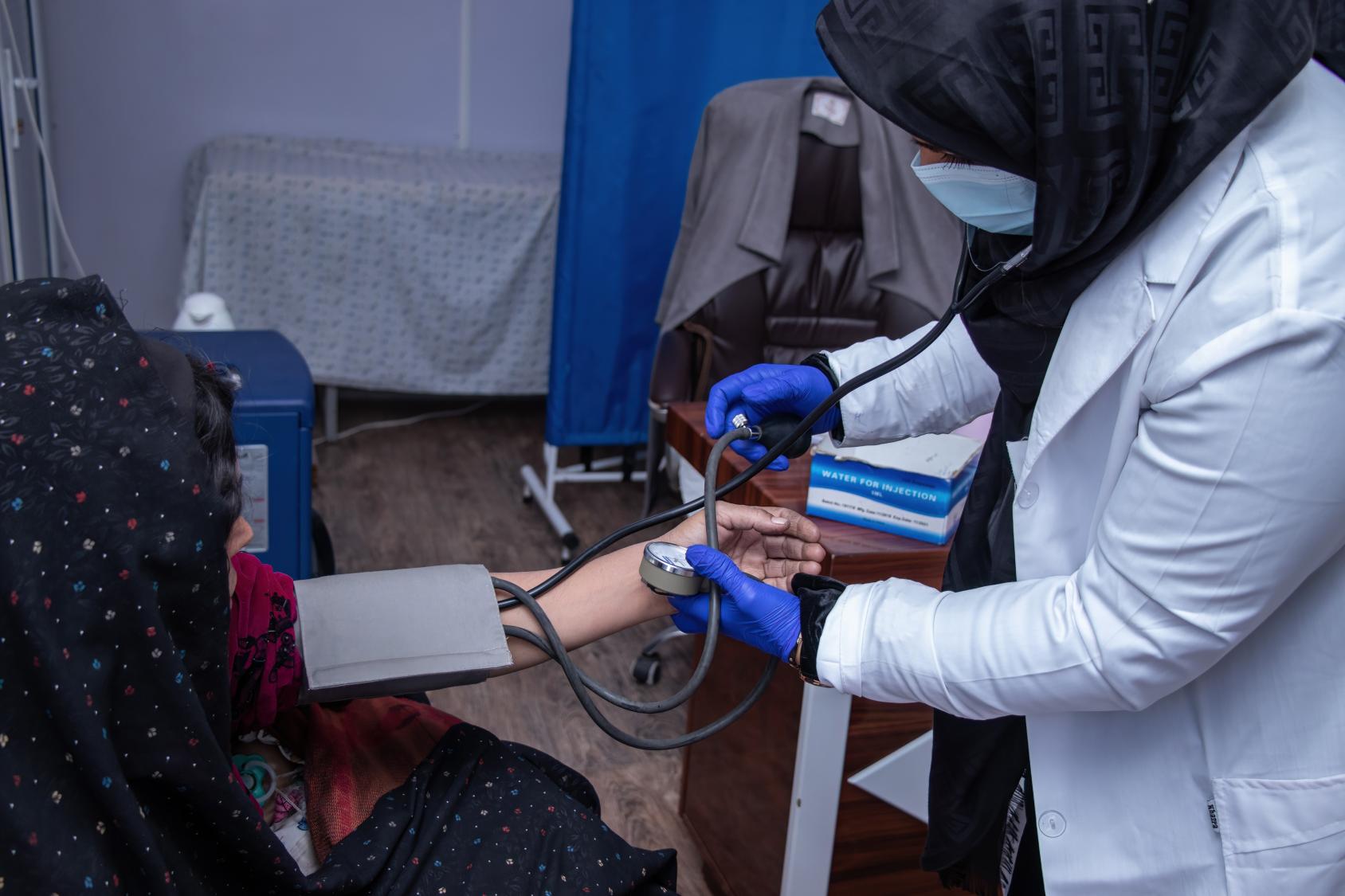 A woman being examined by a female doctor at a family health clinic
