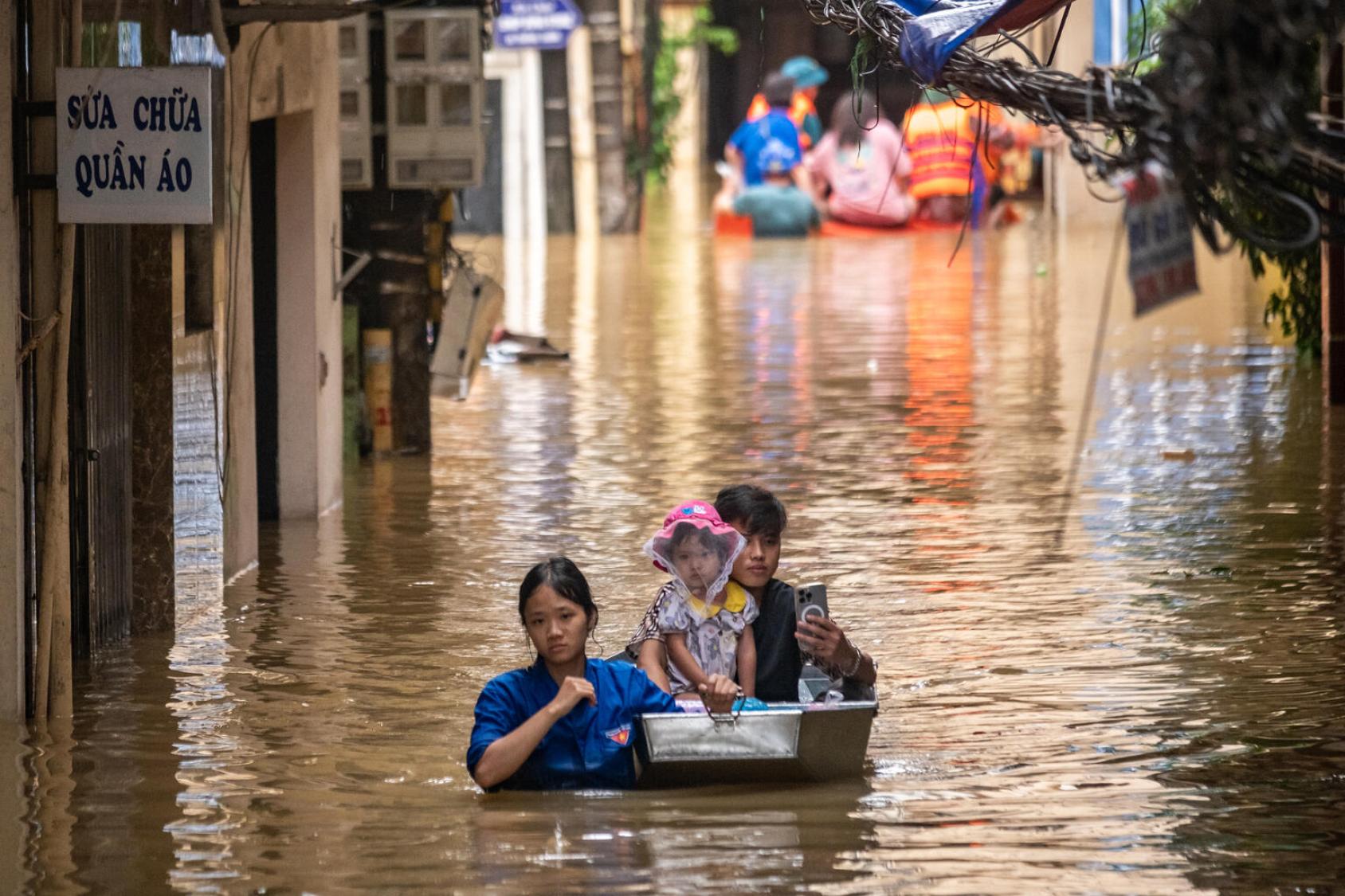 A young family wading through water