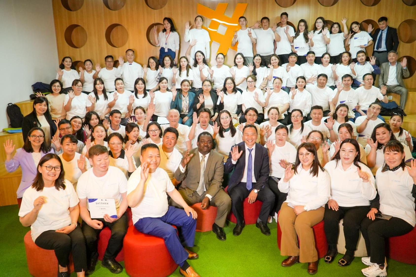 A group of people smile and look at the camera, having completed a training programme on e-services