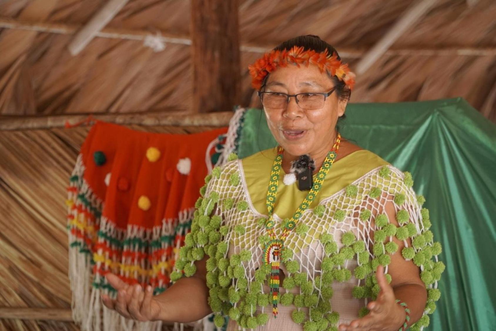 A woman is standing with a microphone