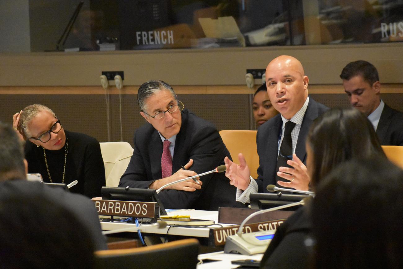 two men and a women sit at a panel discussion 