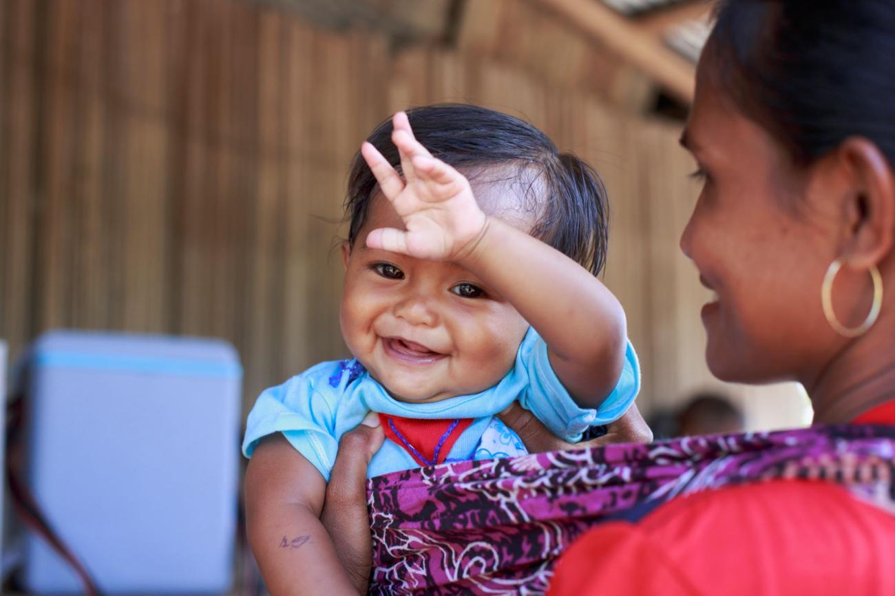 woman stand with back to camera holding child 