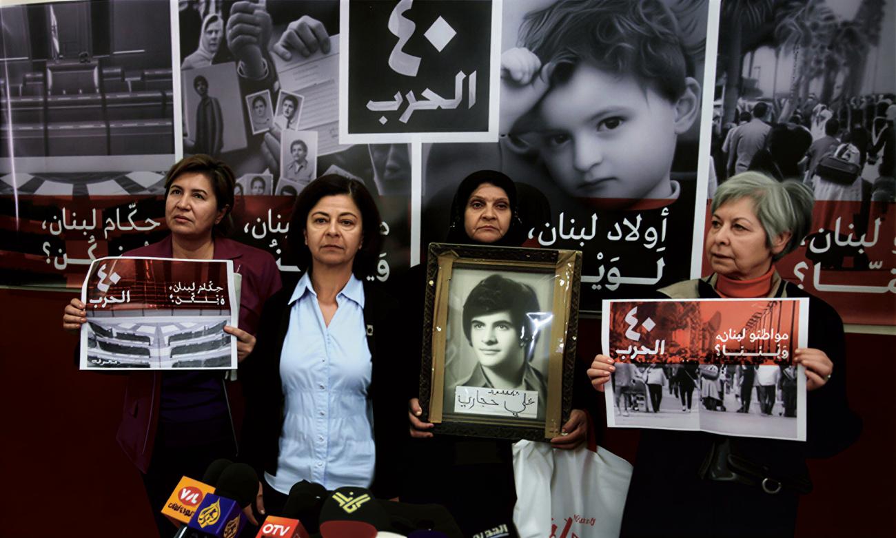 Four women in Lebanon hold photos of their missing relatives.