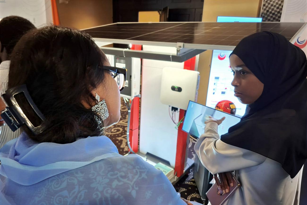A young Djiboutian solar energy entrepreneur presents her company’s products to participants during a forum.