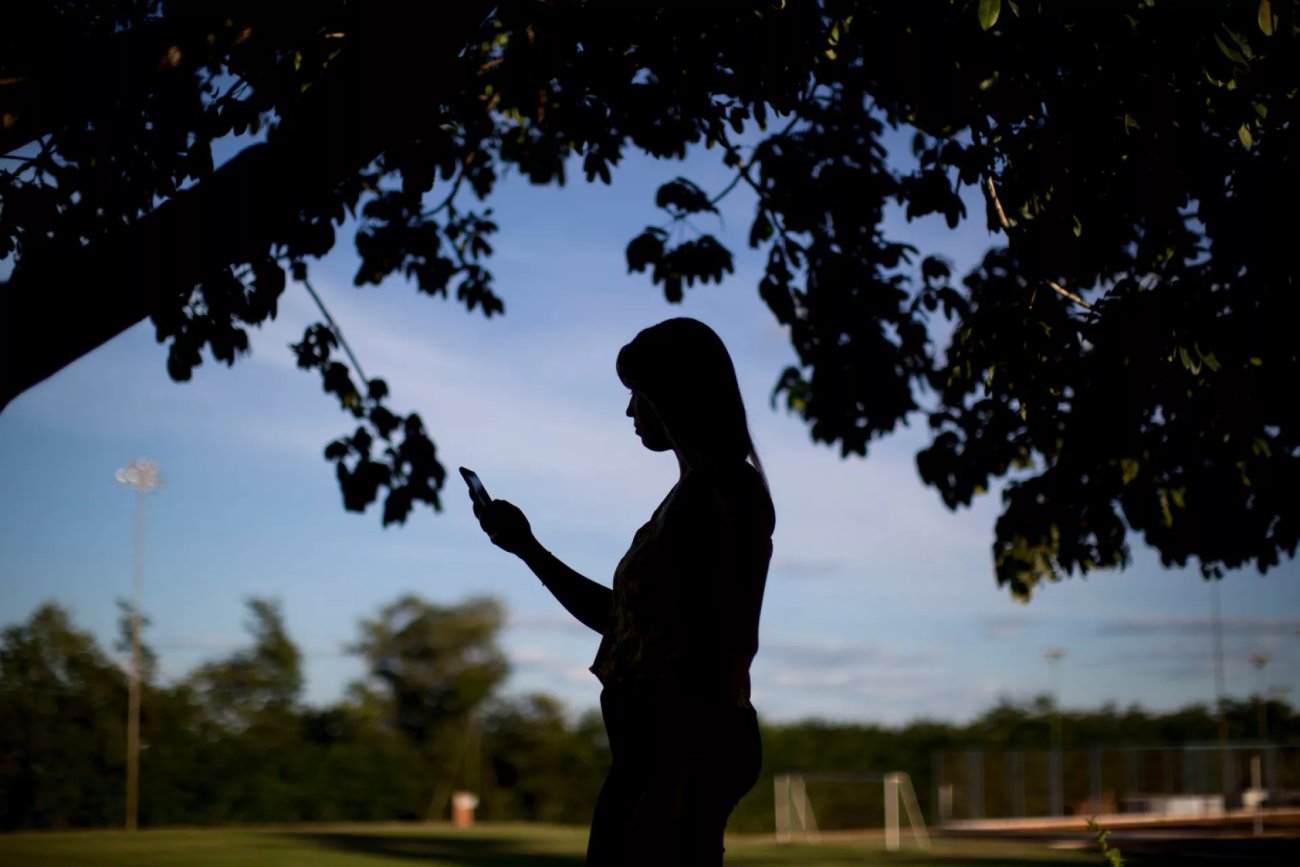 A woman looks at her phone.