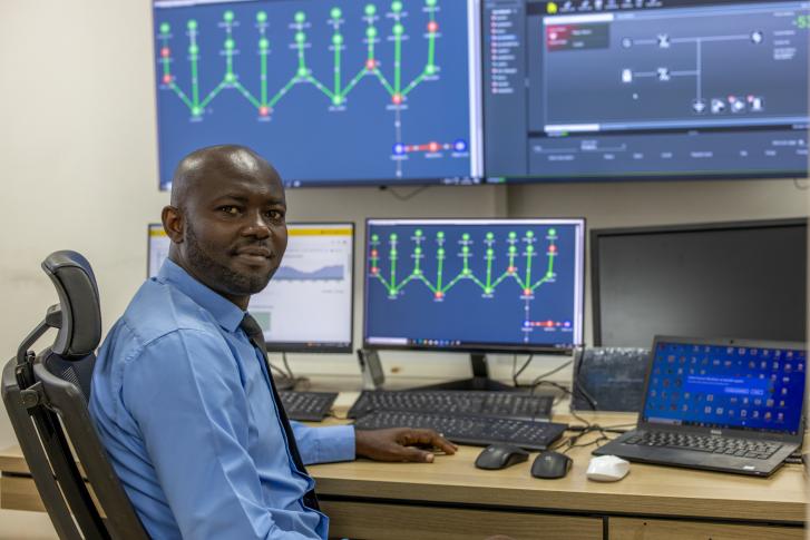a man is seated at a computer looking at numbers