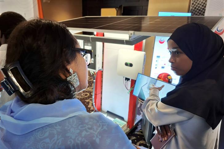 A young Djiboutian solar energy entrepreneur presents her company’s products to participants during a forum.