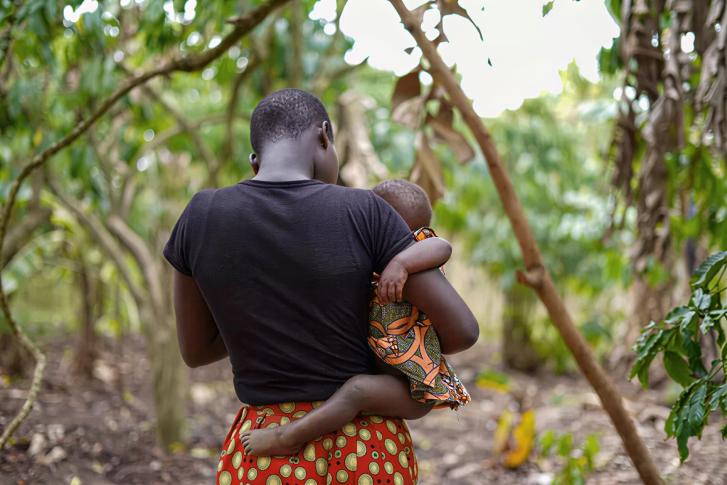 A woman carries her child.