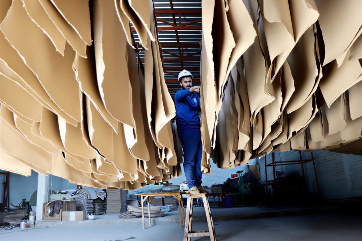 A man in Afghanistan works in a paper factory.