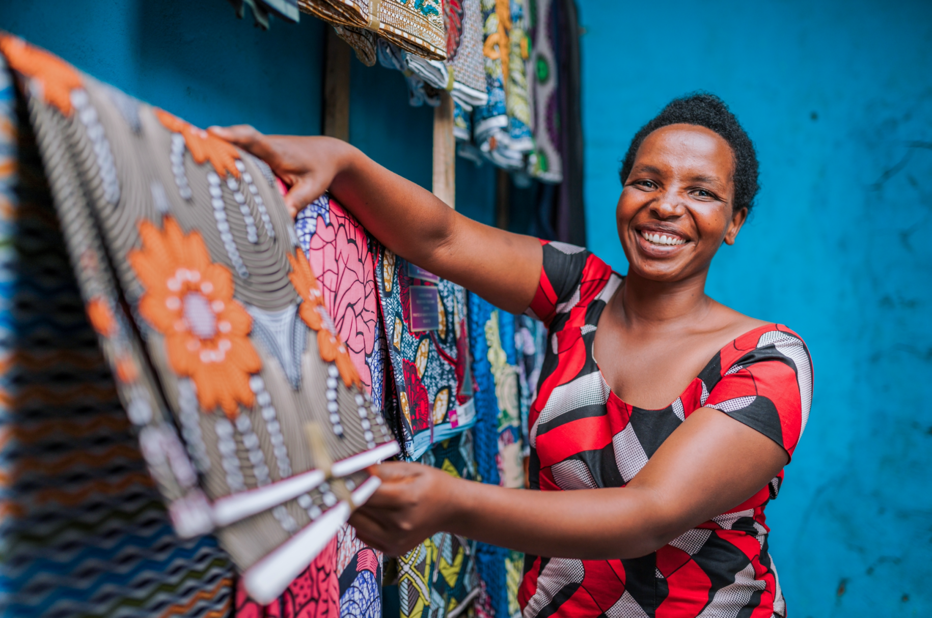 woman folds piece of fabric 