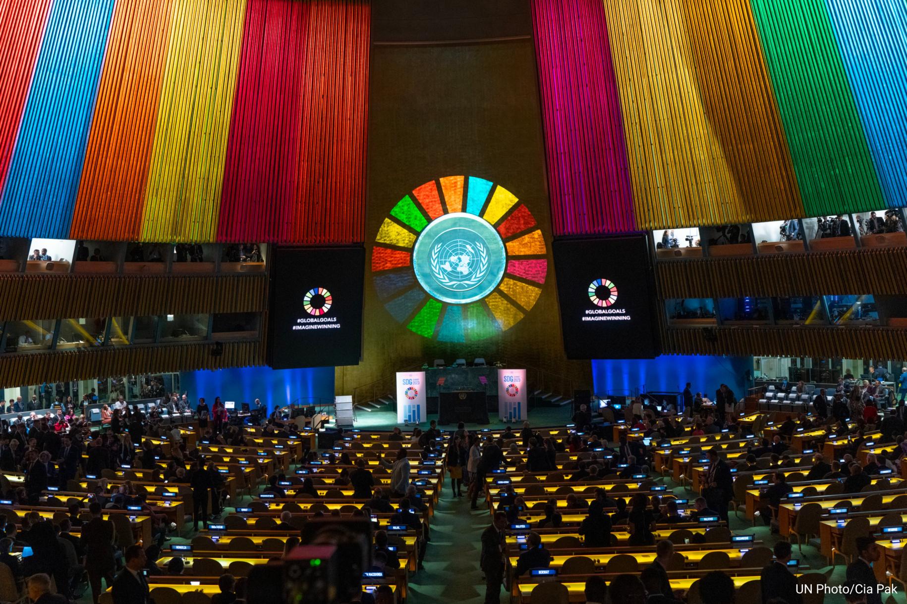 General Assembly hall light up with projection of SDG wheel.