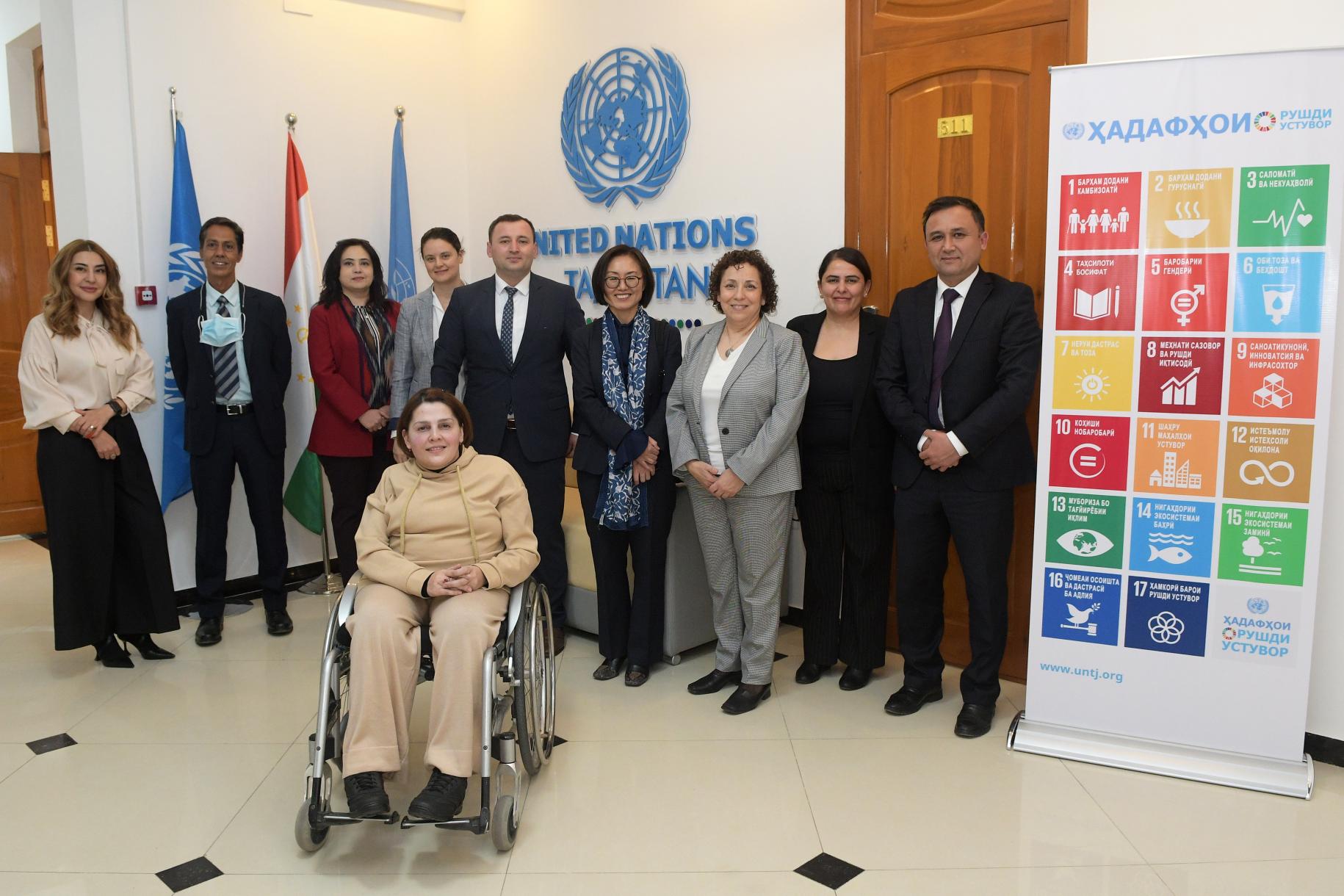 UN colleagues standing side-by-side in the entrance of the UN office in Tajikistan